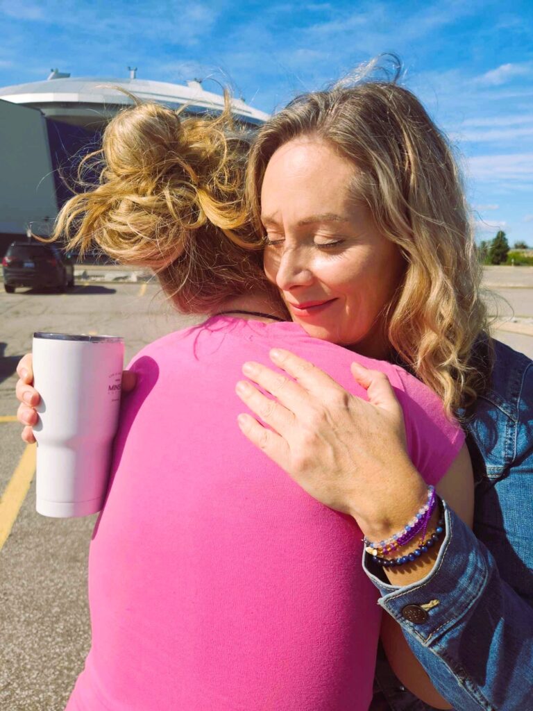 An autistic woman hugging her friend